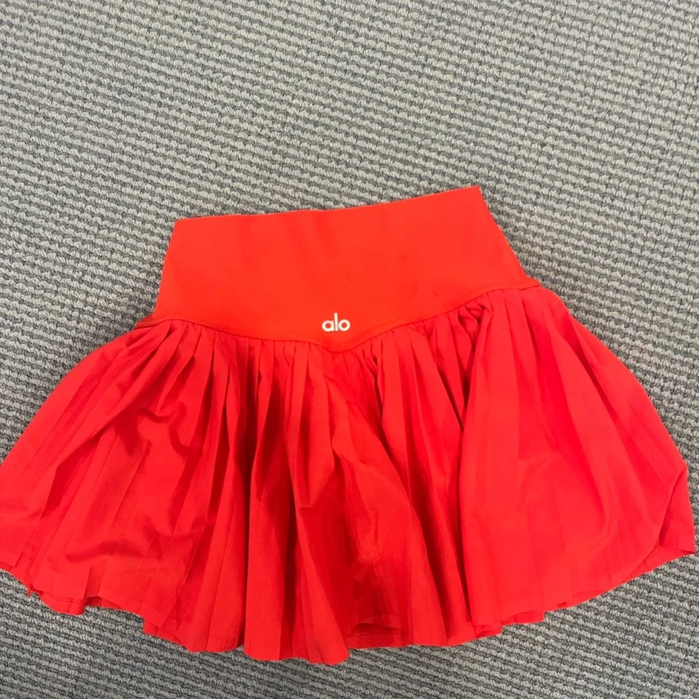 Red pleated also tennis skirt